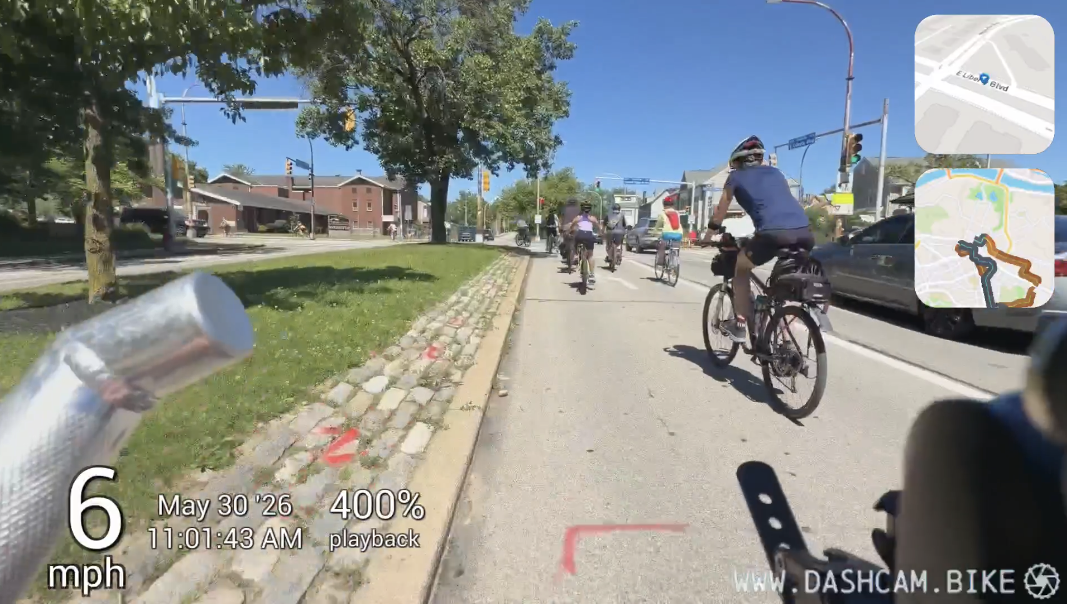 The dashcam.bike recording view with speed, time and mini-maps overlaid on the ride